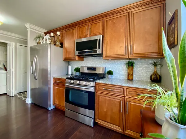 a kitchen with stainless steel appliances a stove a microwave and a refrigerator