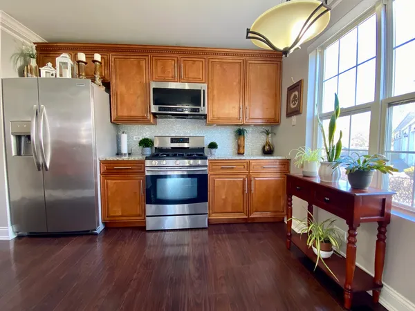 a kitchen with stainless steel appliances a stove a refrigerator sink and microwave