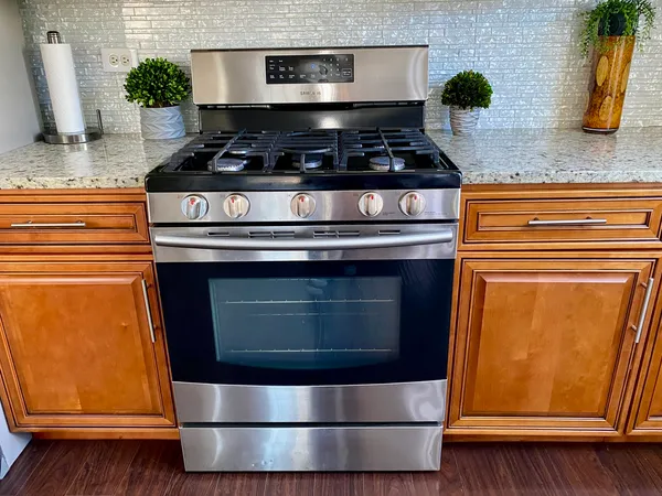 a stove top oven sitting inside of a kitchen