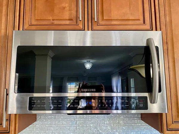 a kitchen with granite countertop a stove and cabinets