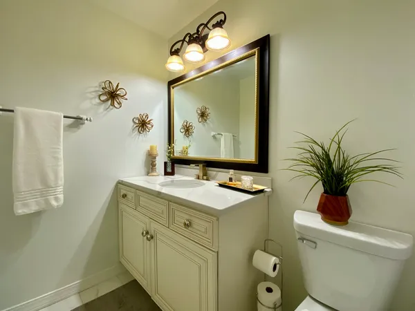 a bathroom with a sink toilet and a mirror