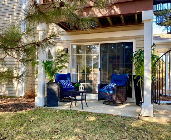 a view of a patio with table and chairs and potted plants