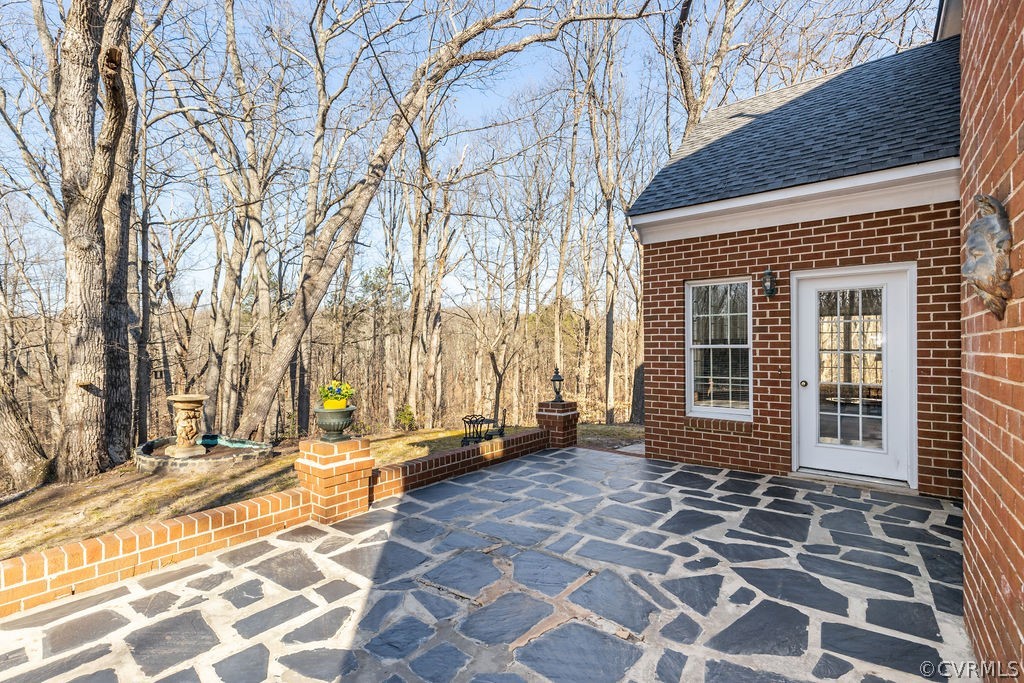 11902 Reeds Bluff Lane Midlothian, VA 23113 - Photo 42 of 42 a view of a brick house with a backyard