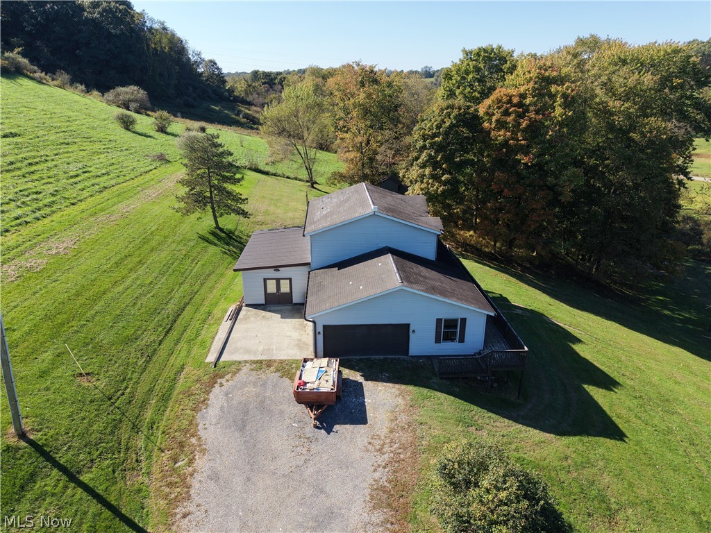3950 Wolf Road Southwest Port Washington, OH 43837 - Photo 40 of 45 Light blue siding exterior with dark shingle roofing, attached garage, and an elevated wood deck