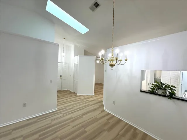 a kitchen with a refrigerator a sink and cabinets