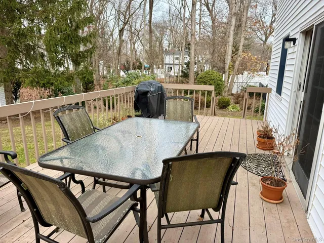 a view of balcony with wooden floor and outdoor seating