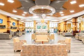 a living room with lots of furniture and a large window