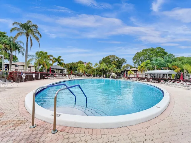 a view of swimming pool with outdoor seating and plants