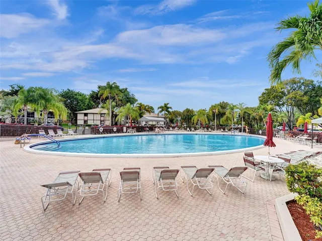 a view of swimming pool with outdoor seating and plants
