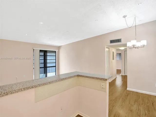 a view of a room with a window and chandelier