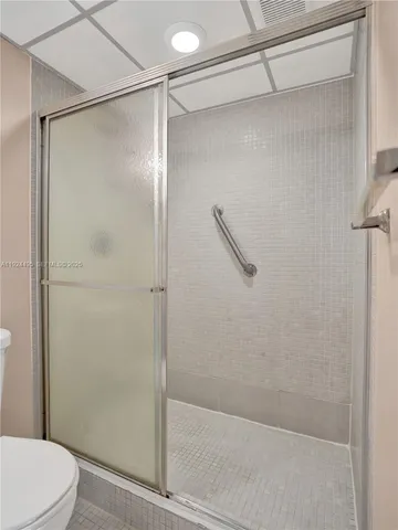 a bathroom with a shower and a toilet