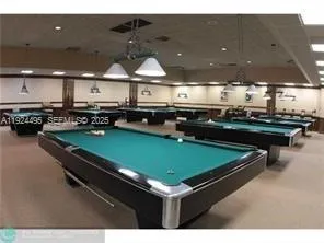 a kitchen with kitchen island a stove and a microwave