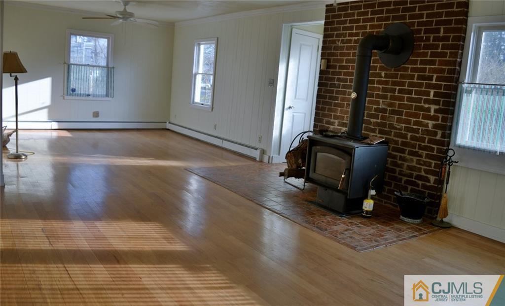 292 Georges Road Dayton, NJ 08810 - Photo 3 of 19 a view of a room with wooden floor and windows