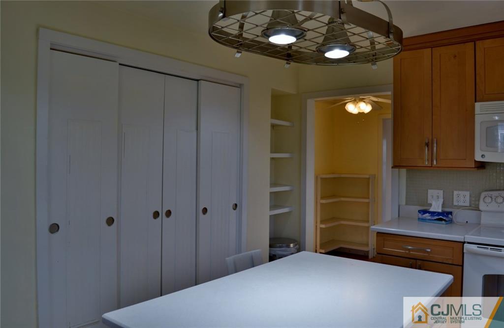 292 Georges Road Dayton, NJ 08810 - Photo 6 of 19 a bedroom with a bed and a chandelier