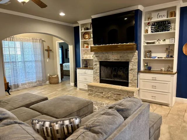 a living room with furniture and a fireplace