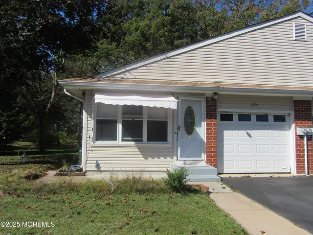 a front view of a house with garage