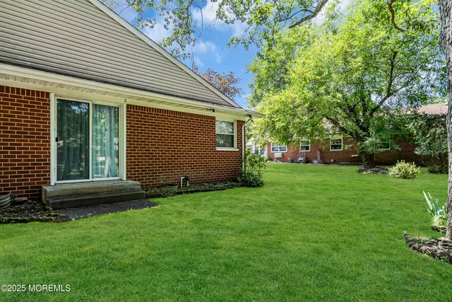 a view of house with backyard