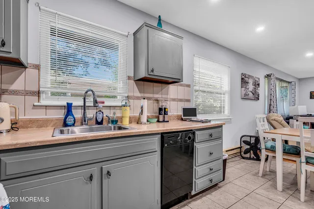 a kitchen with a sink window and cabinets