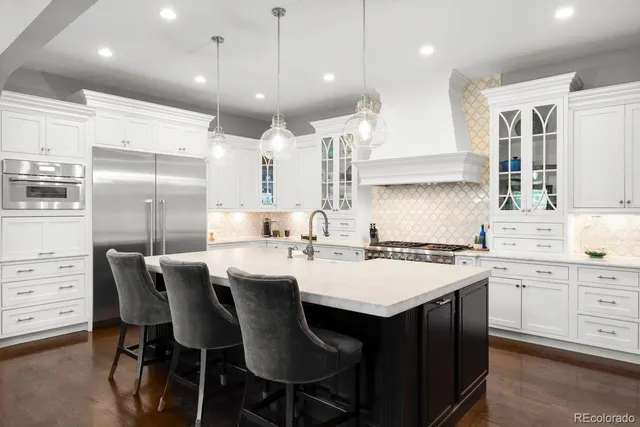a kitchen with a dining table chairs wooden cabinets and white stainless steel appliances