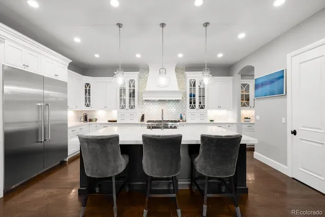 a large kitchen with a table and chairs