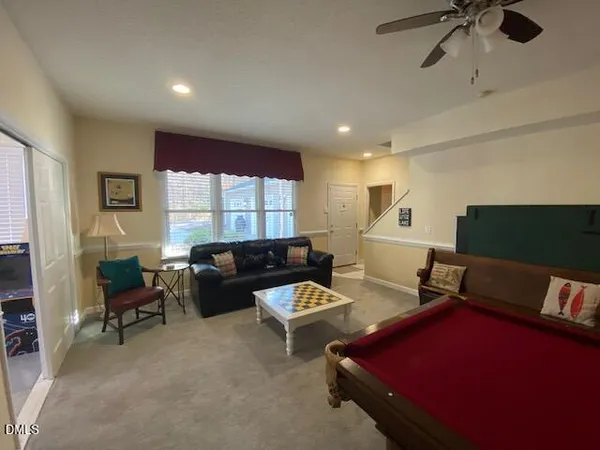 a spacious bedroom with a bed and glass windows