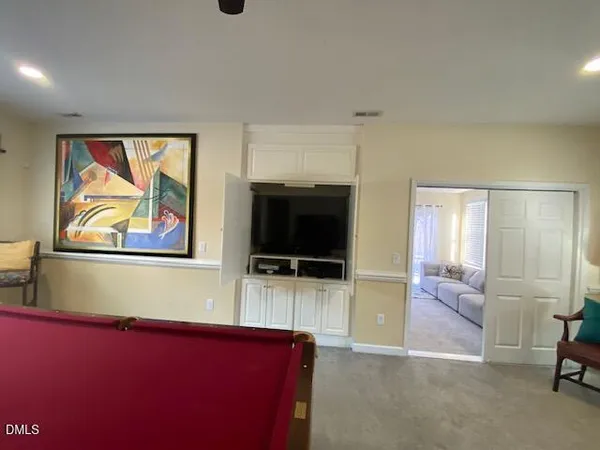 a view of a dining room with furniture and a window