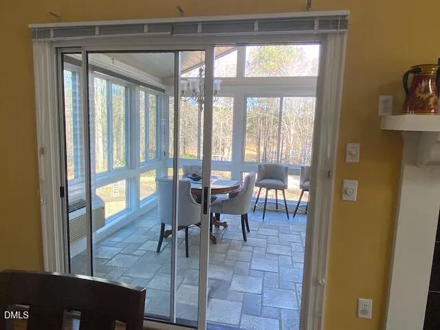 a view of a dining room with furniture large windows and wooden floor