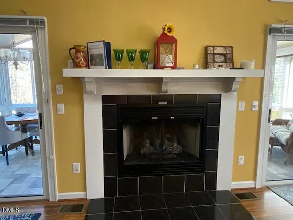 a bedroom with a bed and a lamp on dresser