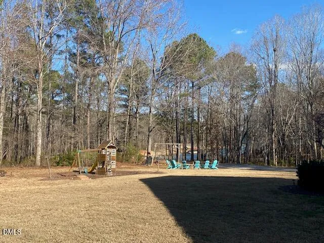a view of backyard with large trees