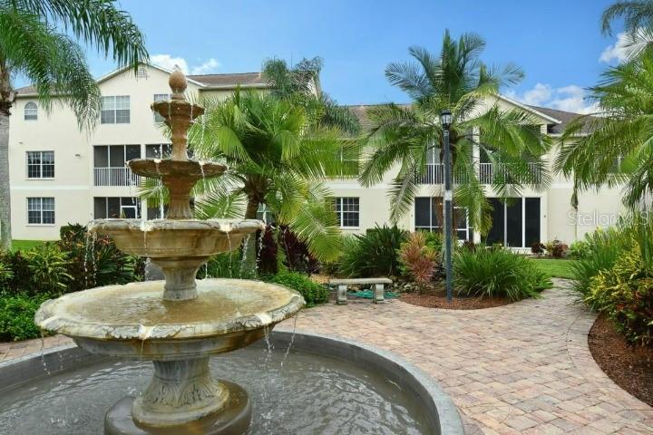a view of a patio with couches table and chairs potted plants and palm tree