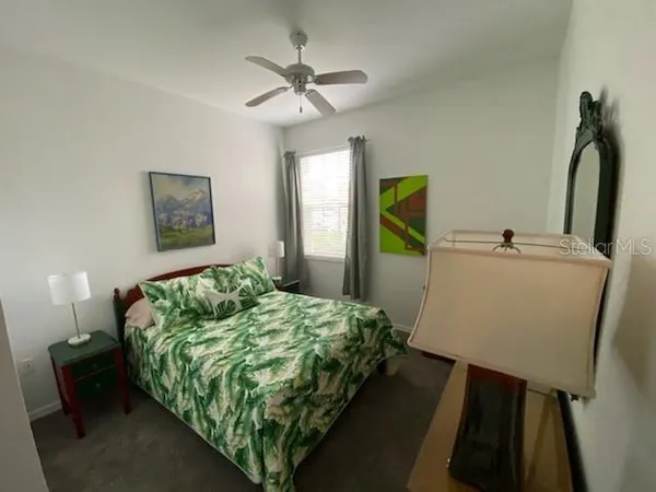 a bedroom with a bed and a mirror