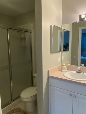 a bathroom with a sink toilet and mirror