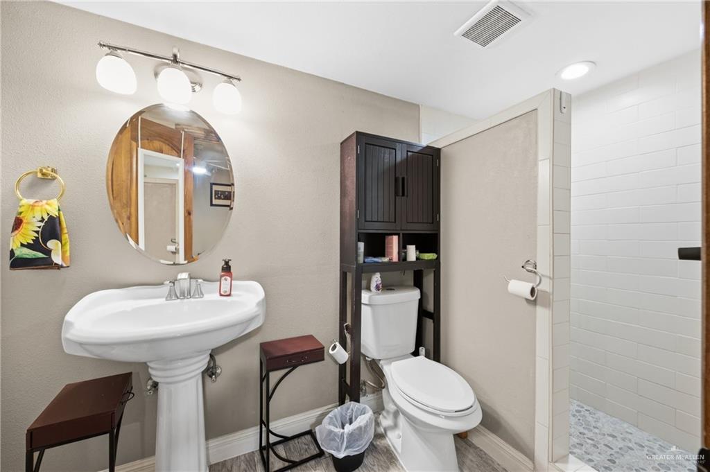 1811 Victoria Street Mission, TX 78572 - Photo 12 of 19 a bathroom with a toilet sink and mirror