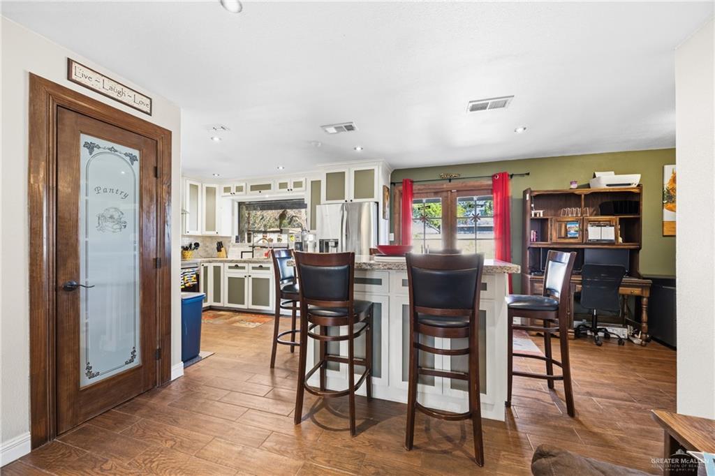 1811 Victoria Street Mission, TX 78572 - Photo 5 of 19 a view of a dining room with furniture and wooden floor