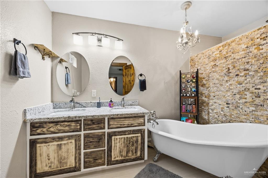 1811 Victoria Street Mission, TX 78572 - Photo 7 of 19 a bathroom with a double vanity sink mirror and bathtub