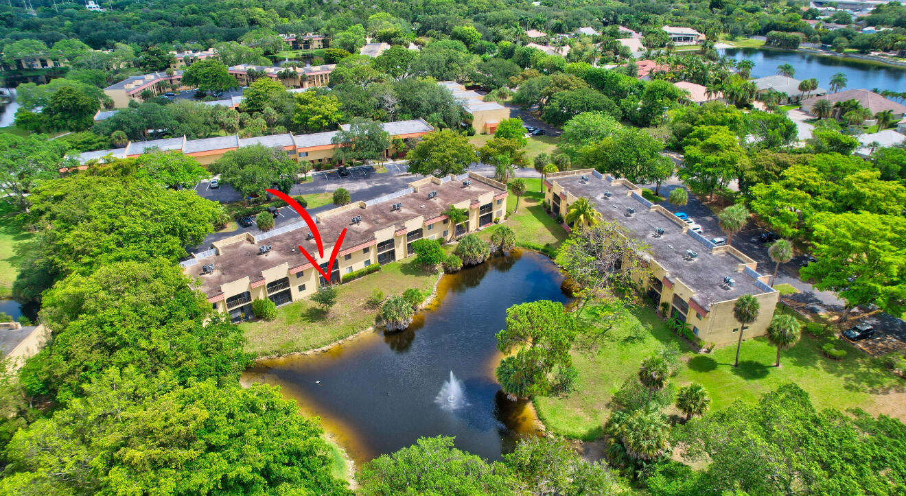 an aerial view of residential houses with outdoor space and trees
