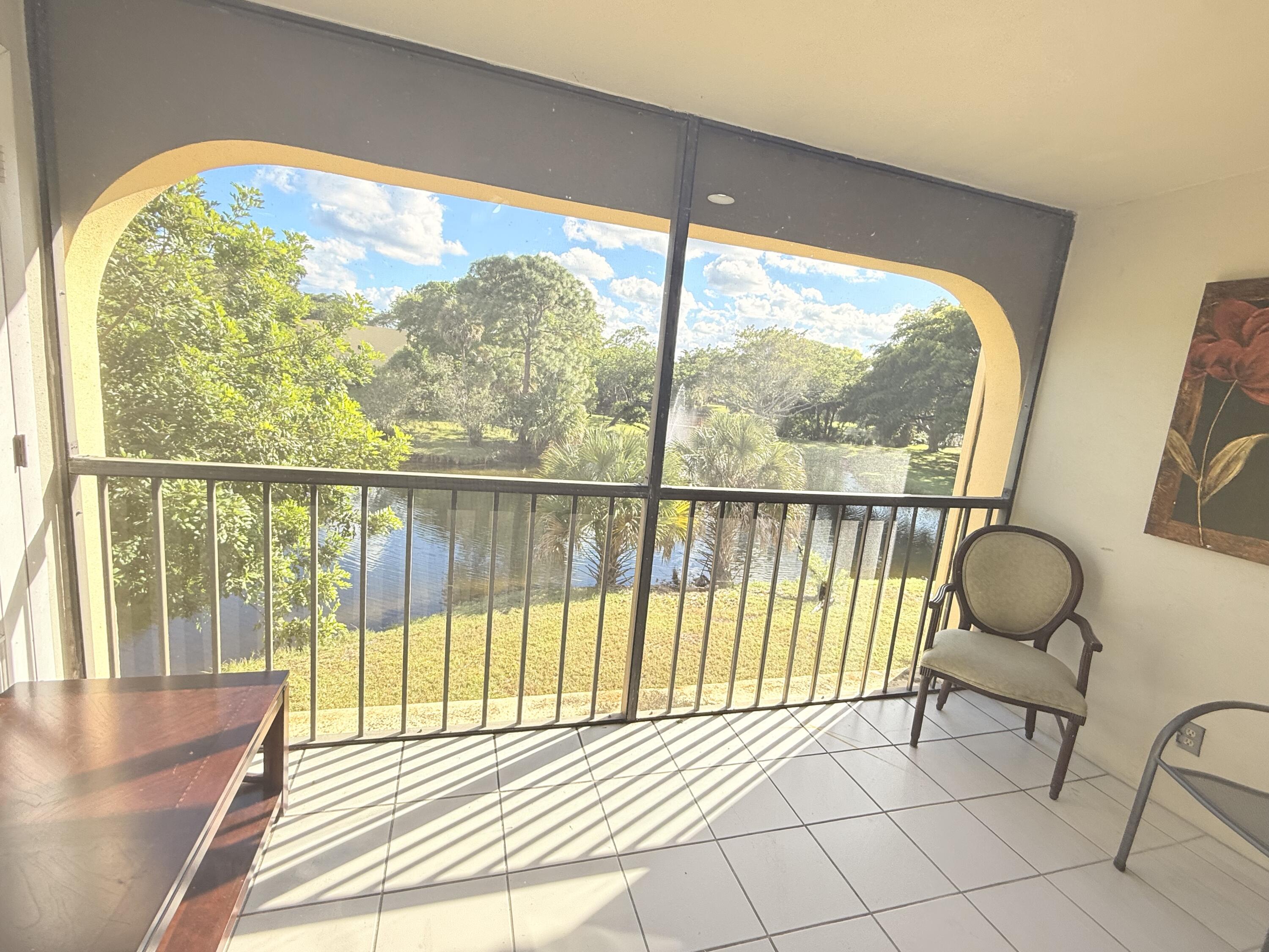 906 Southwest 9th St Circle, Unit 204 Boca Raton, FL 33486 - Photo 23 of 39 a view of a room and wooden floor windows