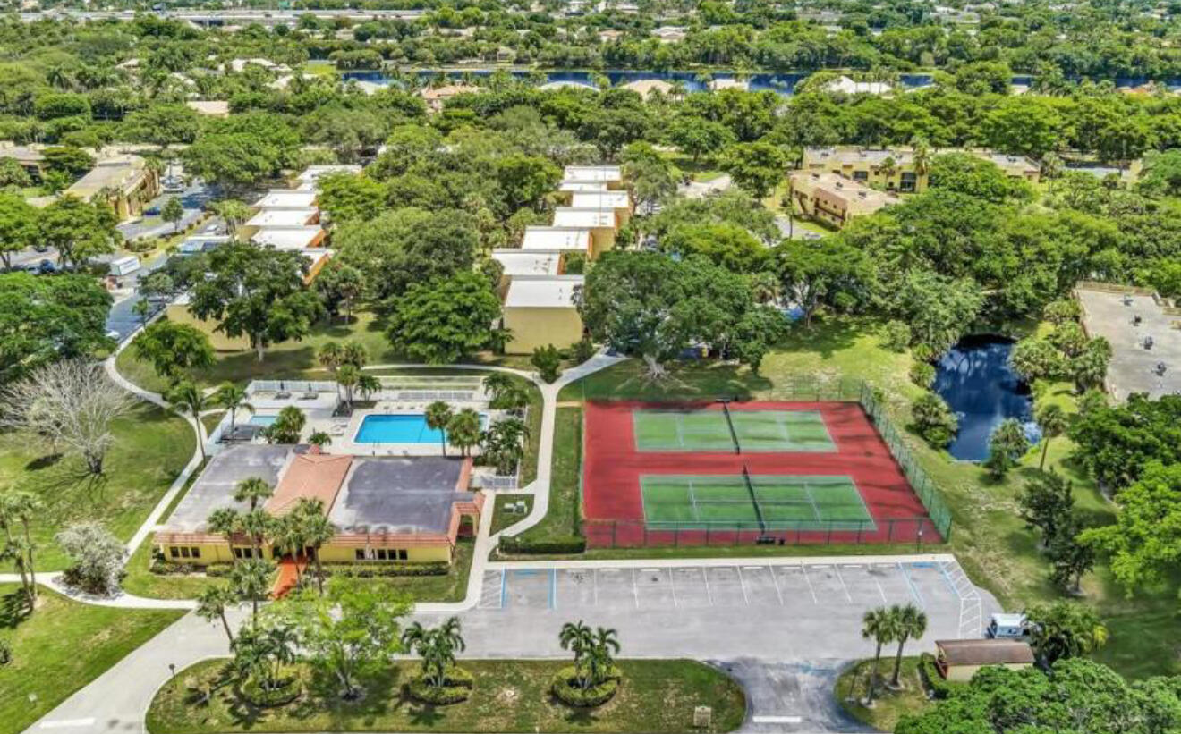 906 Southwest 9th St Circle, Unit 204 Boca Raton, FL 33486 - Photo 36 of 39 an aerial view of residential houses with outdoor space and trees