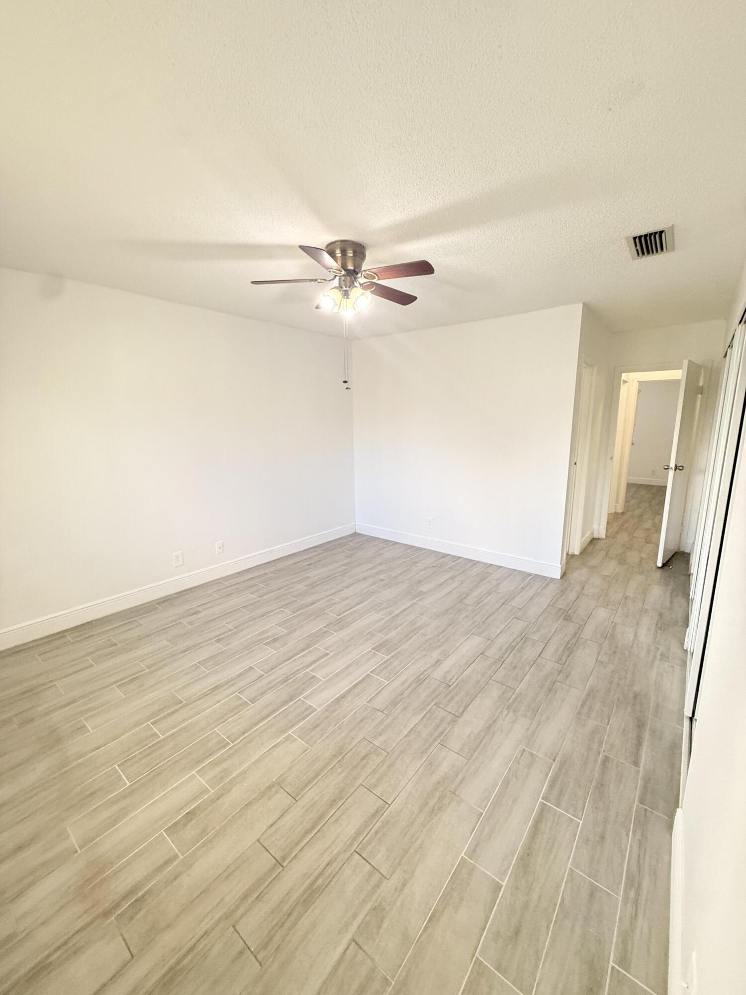 906 Southwest 9th St Circle, Unit 204 Boca Raton, FL 33486 - Photo 10 of 39 a view of a room with wooden floor