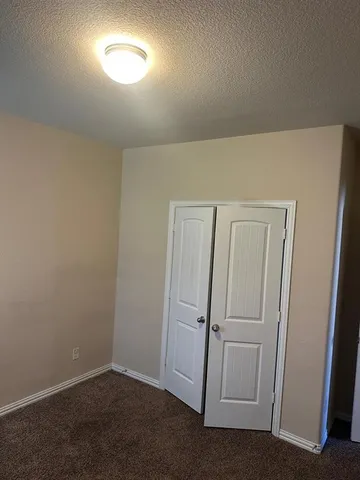 an empty room with closet area
