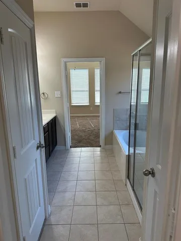 a bathroom with a granite countertop sink a mirror and a shower