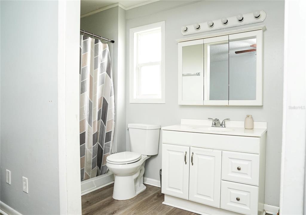 821 Barber Street Sebastian, FL 32958 - Photo 11 of 29 a bathroom with a sink a toilet and a mirror