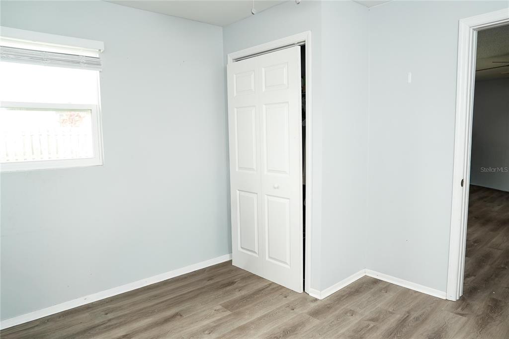821 Barber Street Sebastian, FL 32958 - Photo 20 of 29 a view of an empty room with wooden floor and a window