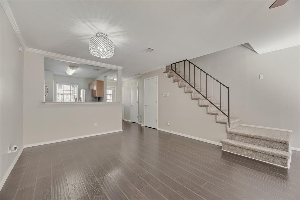 43 Abbey Road Euless, TX 76039 - Photo 8 of 22 a view of an empty room with wooden floor and a window
