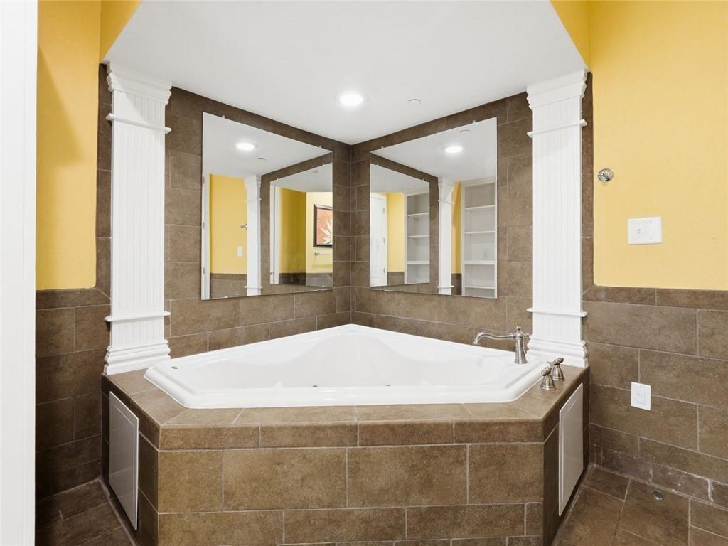 150 Apple Seed Court, Unit 131 Clarkesville, GA 30523 - Photo 15 of 40 a bathroom with a tub and large windows