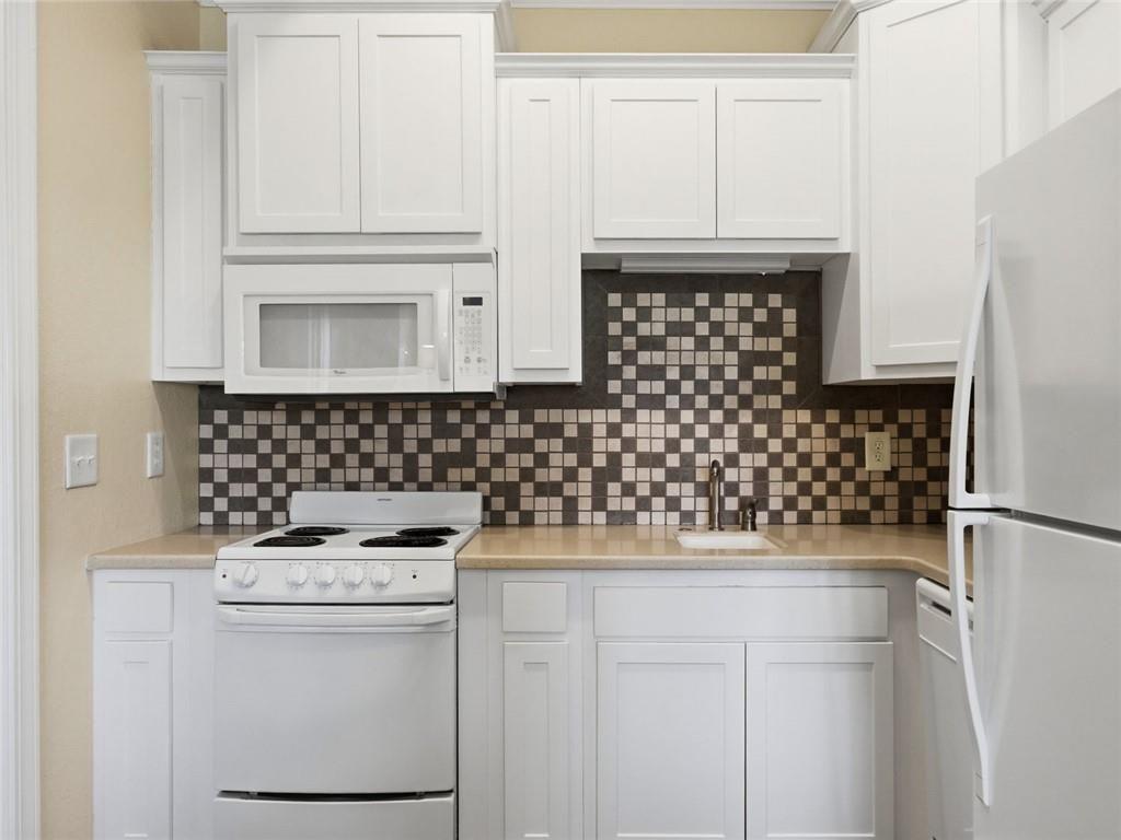 150 Apple Seed Court, Unit 131 Clarkesville, GA 30523 - Photo 2 of 40 a kitchen with a refrigerator and a stove
