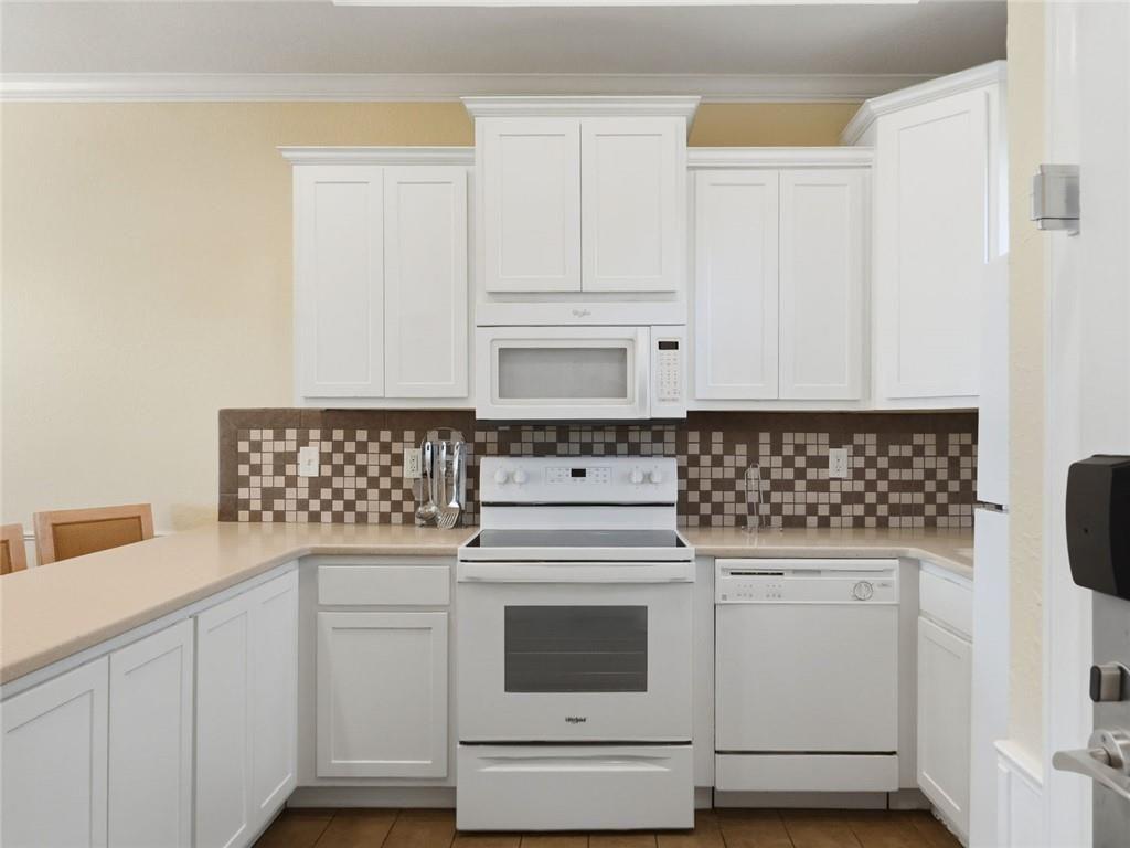 150 Apple Seed Court, Unit 131 Clarkesville, GA 30523 - Photo 25 of 40 a kitchen with white cabinets and white appliances