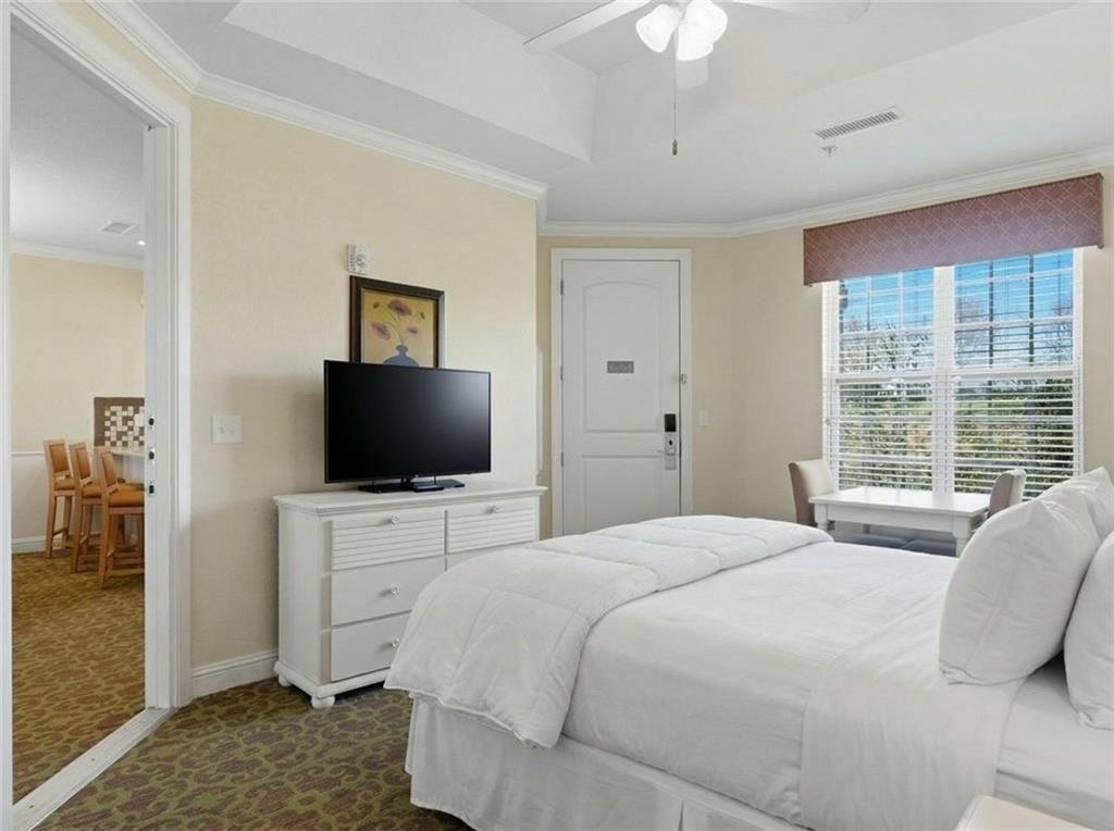 150 Apple Seed Court, Unit 131 Clarkesville, GA 30523 - Photo 32 of 40 a bedroom with a bed and a flat screen tv