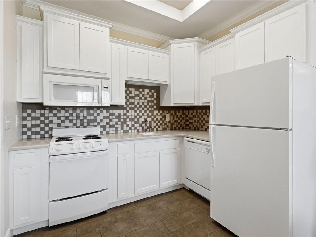 150 Apple Seed Court, Unit 131 Clarkesville, GA 30523 - Photo 34 of 40 a kitchen with white cabinets and white appliances