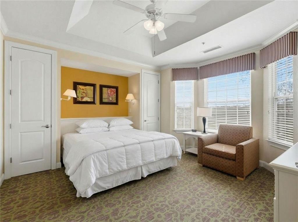 150 Apple Seed Court, Unit 131 Clarkesville, GA 30523 - Photo 8 of 40 a bedroom with a bed couch and window